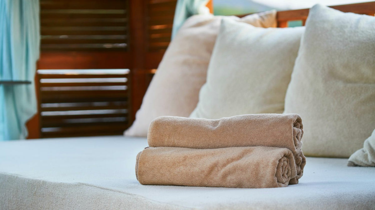 three bathtowels on bed