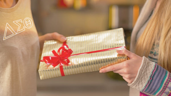 woman giving gift to her sorority sister