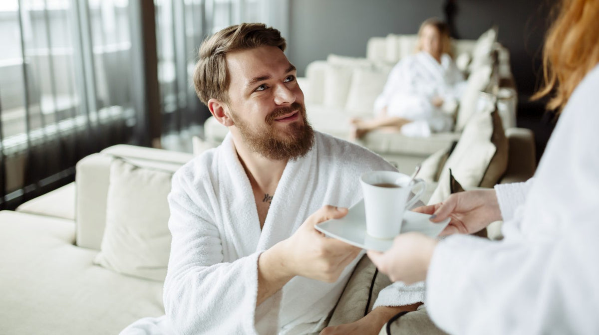handsome man wearing robe and drinking tea in the morning