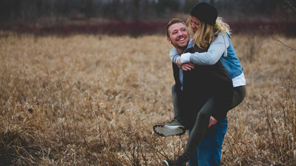 man carrying woman standing on the ground