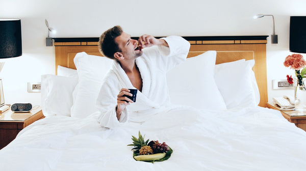 man wearing a robe on bed