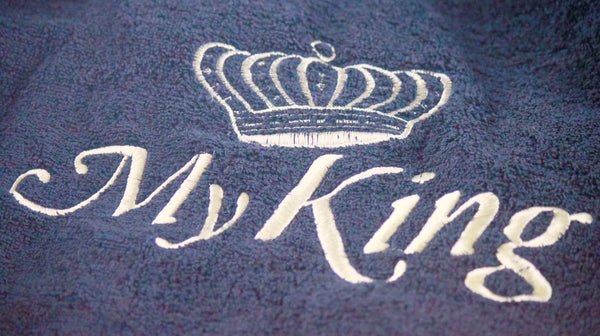 text letters embroidered on dark towels