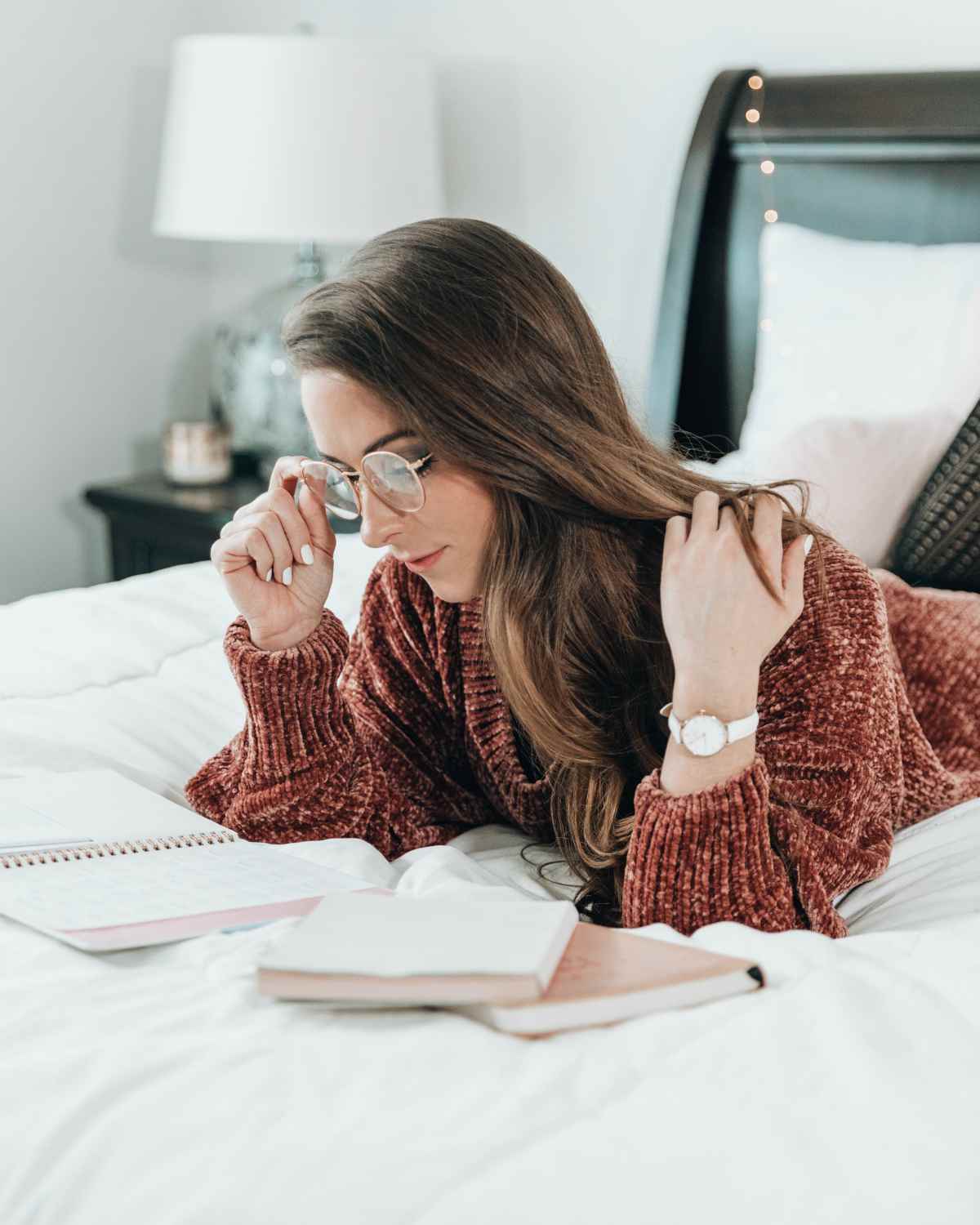 Woman reading in bed | Celebrity Bedtime Routines That Actually Help You Get To Sleep