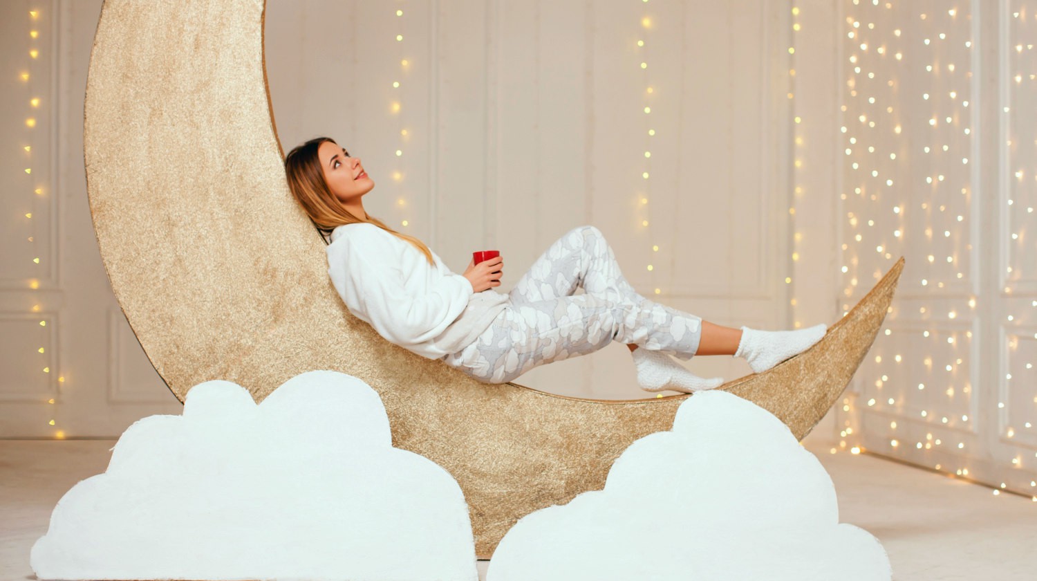 Featured | Girl in Warm light Pajamas lying on a Golden Month with a cup of Milk with Honey, Relax Before Going to Bed | Reasons To Wear Real Pajamas
