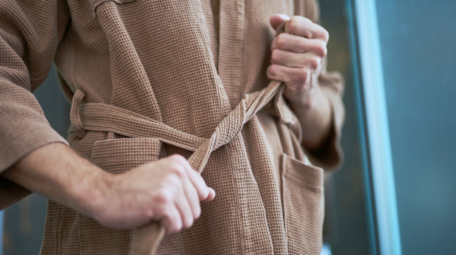 man tying his bathrobe | Things To Consider When Purchasing A Men's Robe | men's robe | waffle men's robe | Featured