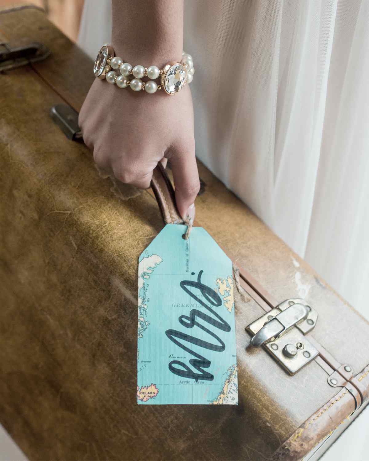 bride holding luggage with personalized tag | Best Bachelorette Party Favors For The Best Bride Squad | bachelorette party favors | personalized bachelorette party favors
