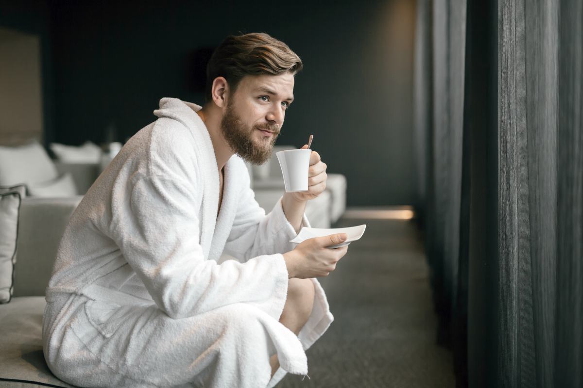man wearing bathrobe while drinking tea | Things To Consider When Purchasing A Men's Robe | men's robe | cotton men's robe