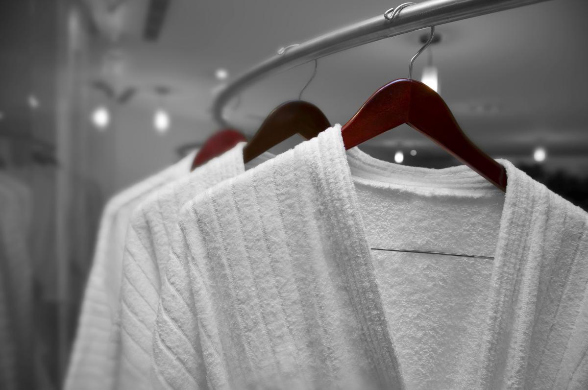 wite robes on wodden hangers | How To Take Care Of Your Cotton, Silk, And Linen Robe/Bathrobes | bathrobes | bathrobes for men