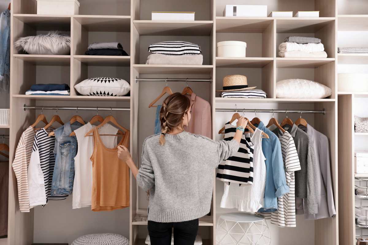 woman organizing her wardrobe | How To Start A Minimalist Wardrobe | minimalist wardrobe | minimalist wardrobe womens