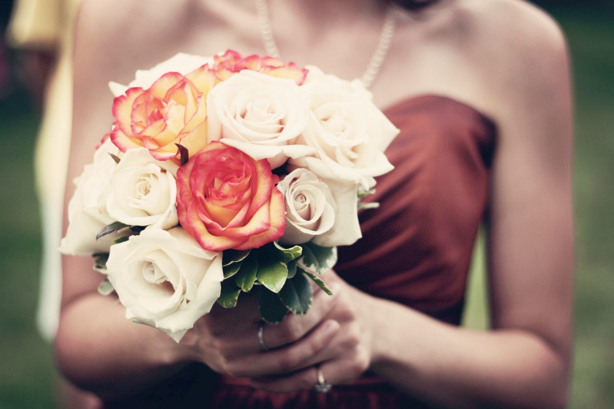 woman holding bouquet of flowers | One-Stop Fall Wedding Planning Guide | fall wedding | budget and etiquette fall wedding planning