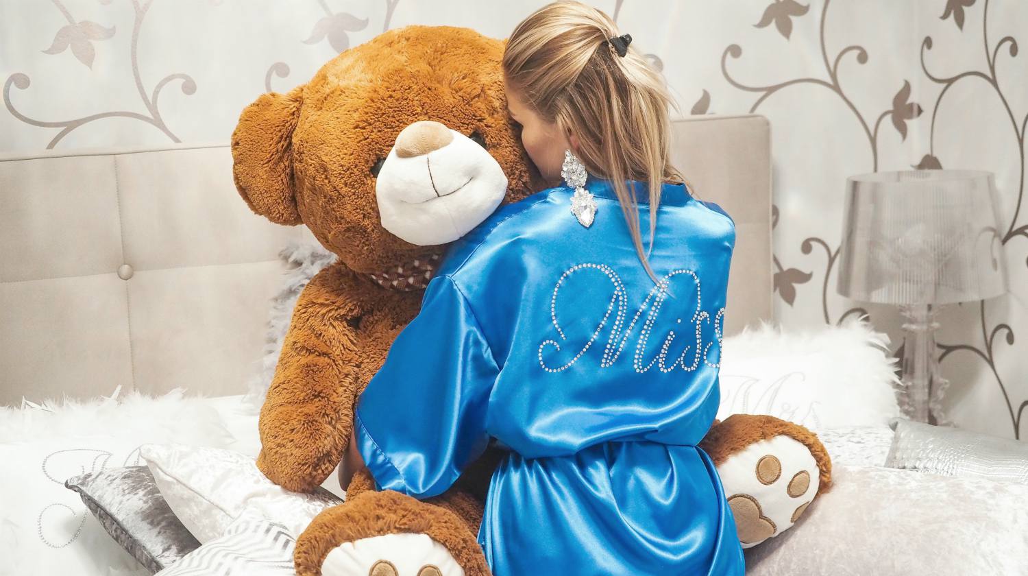 woman wearing custom robe hudding a big teddy bear | Why Personalized Robes Are A Perfect Gift | personalized robes | personalized robes for her | Featured