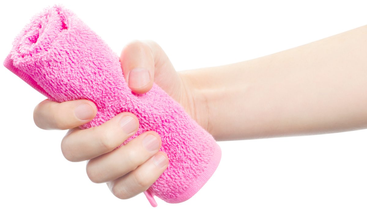 hand holding a grip of pink towel | How To Choose The Best Workout Towel For Your Gym Facility | gym towel | best gym towel shower