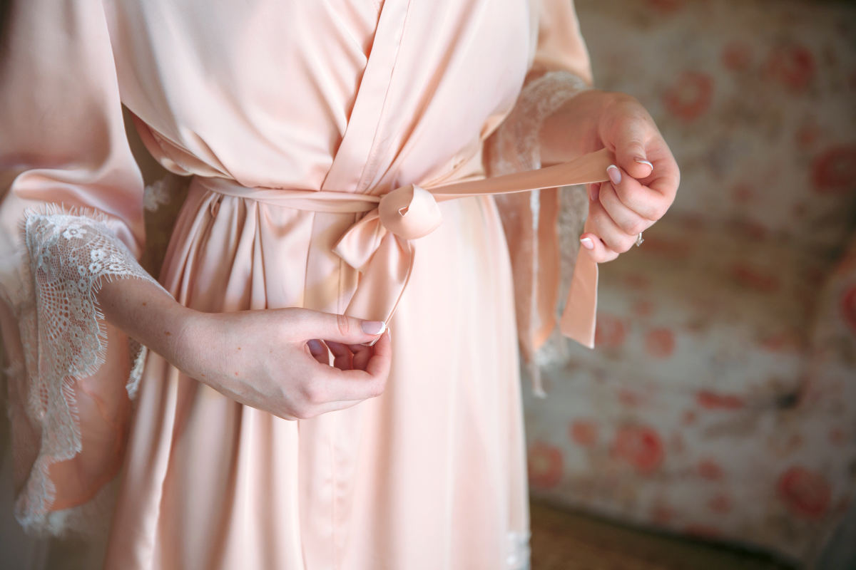 Close-up bride ties belt on her robe | Reasons Why Kimono Robes Are A Must Have Accessory