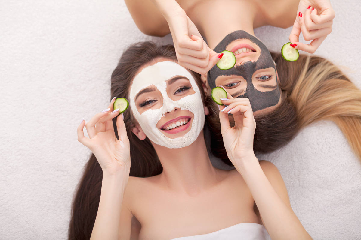 A picture of two girls friends relaxing with facial masks | Plan The Perfect Slumber Party With This Checklist