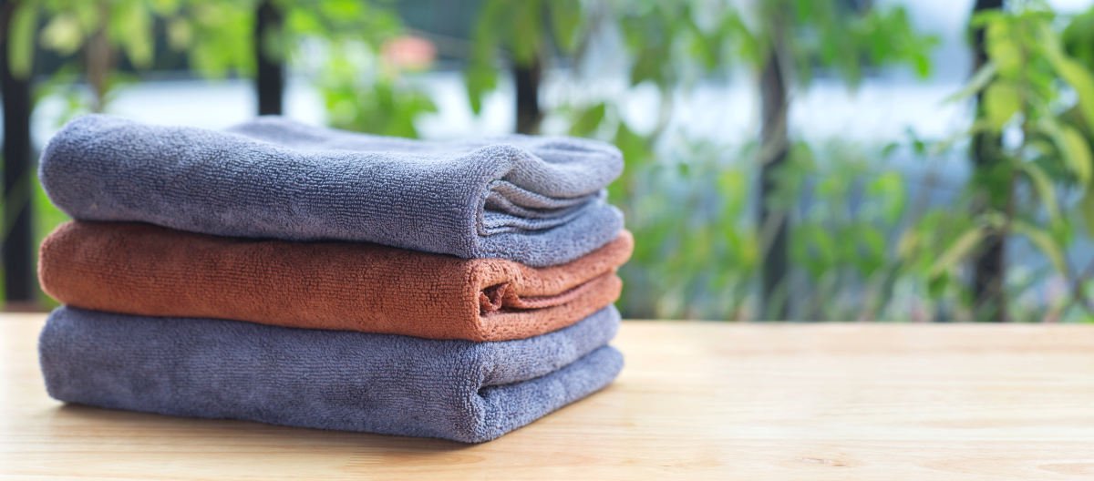 Stack of microfiber cloth on table with copy space | How To Wash Microfiber Cloth Towels and Robes 