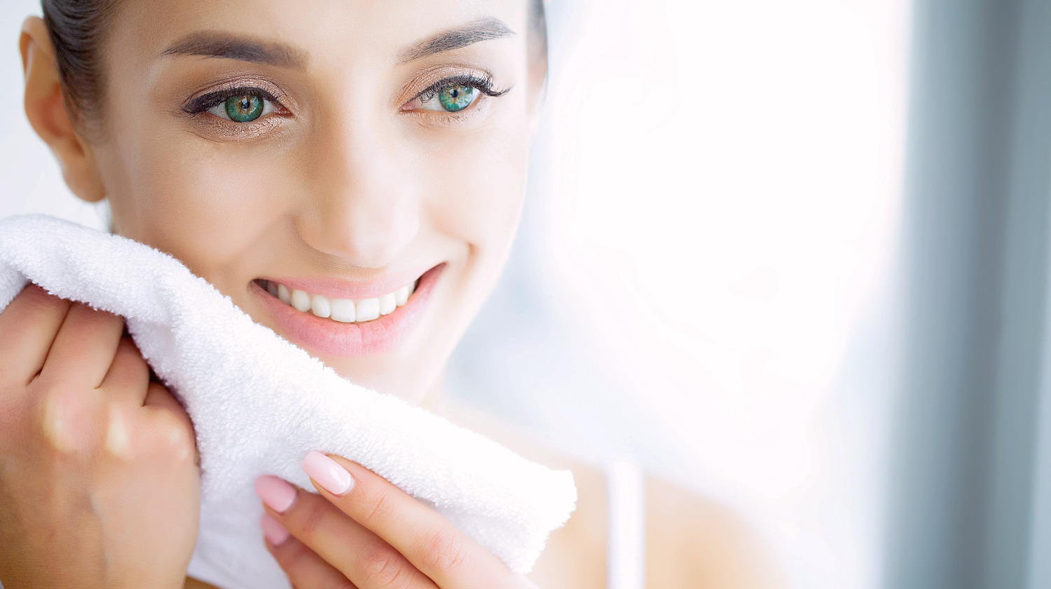 Featured | Beautiful Young Girl with White Teeth Holding a White Towel in Hands | Face Towel Vs Hand Towel: When To Use Which? | Hand Towels