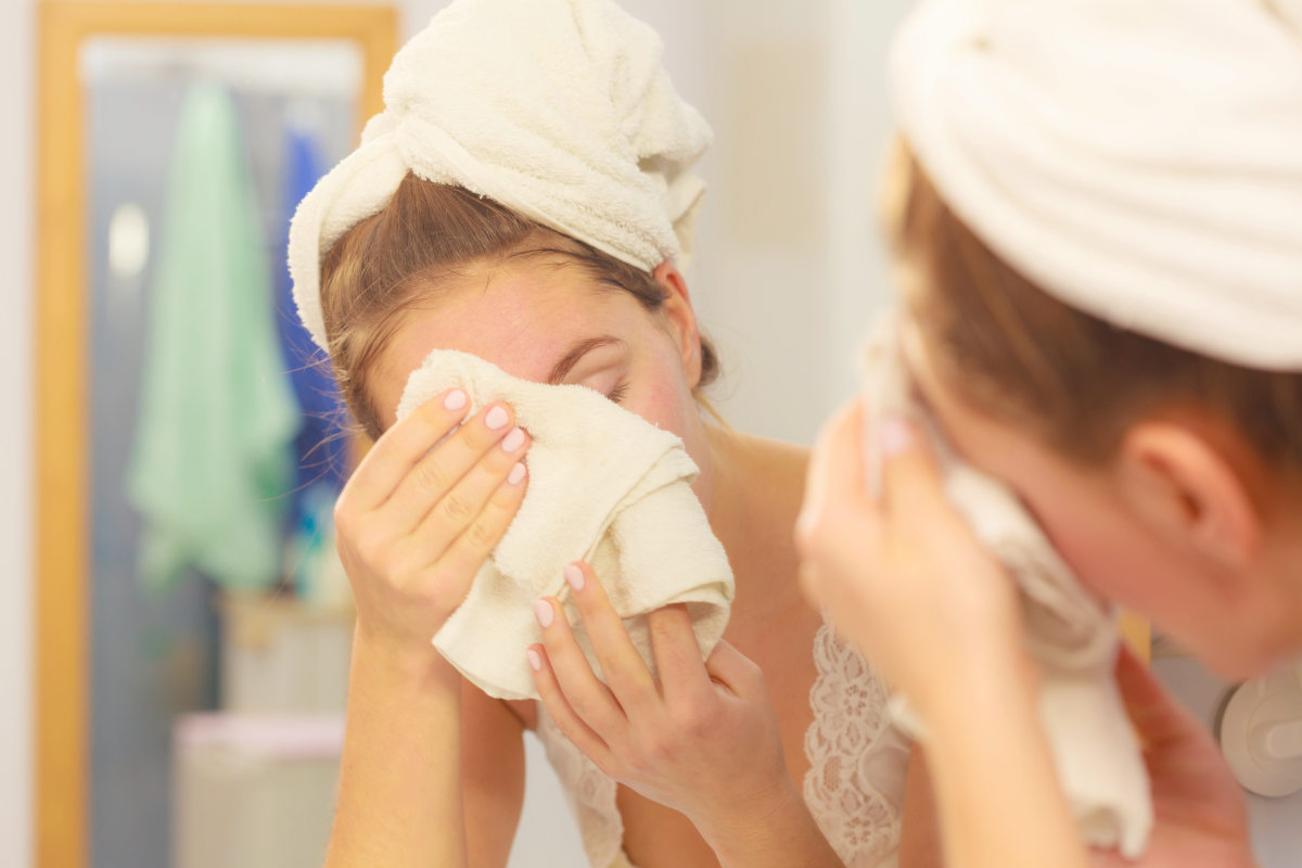 Woman cleaning washing her face | Face Towel Vs Hand Towel: When To Use Which? | Hand Towels