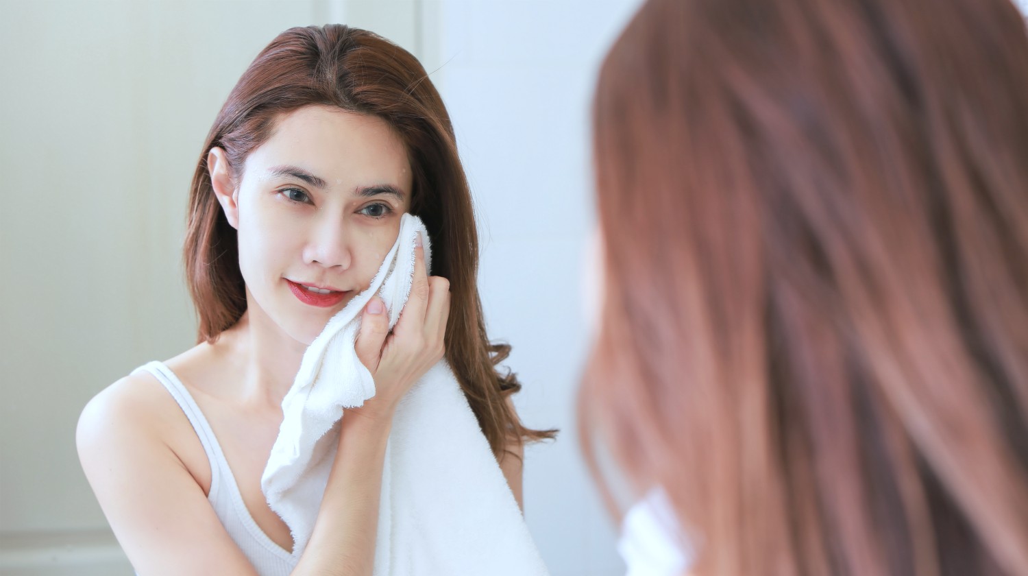 Featured | young woman wiping her face | Why Does Bathrobe and Towel Absorbency Matter? | absorbency | towel absorbency