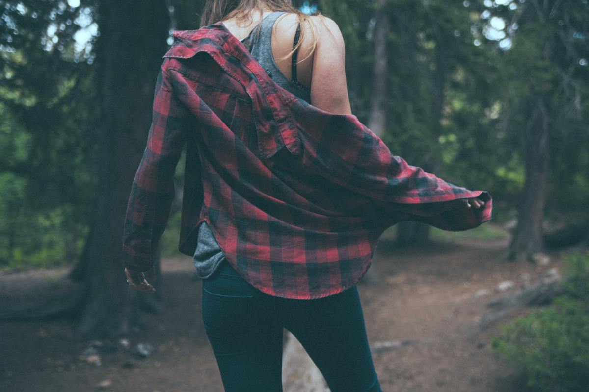 woman wearing flannel shirt in a forest | Comfy Lounge Clothes To Wear At Home That’s Not Your High School Sweatpants | comfy clothes | comfy clothes brand