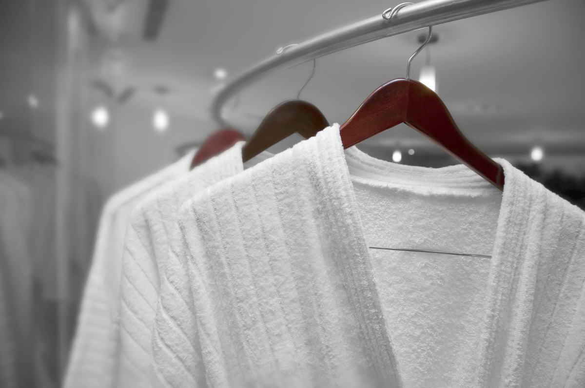 white robes on wodden hangers | Things To Consider When Purchasing A Men's Robe | men's robe | plus size men's robe