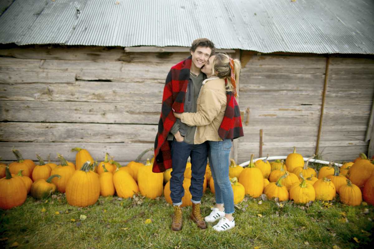 woman kissing man near pumpkins | Fun Fall Date Ideas For Any Relationship Stage | fall date ideas | date night ideas