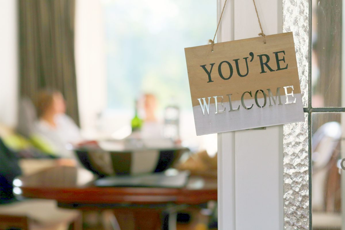 welcome sign on wood hanging on the door | Ways To Be The Best Bed And Breakfast Host | best bed and breakfast | romantic bed and breakfast