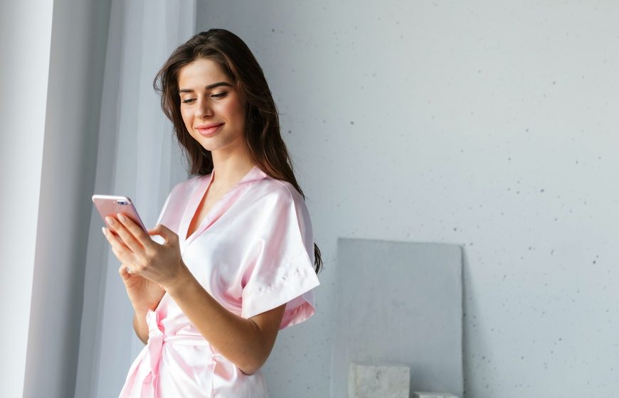 beautiful young woman wearing robe standing | Ways To Improve Hotel Guest Experience | hotel guest | customer experience | Featured