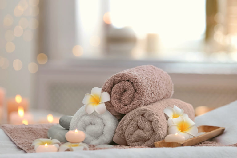 Beautiful spa composition on massage table in wellness center | Simple Tips For Buying Wholesale Salon Towels | microfiber salon towels wholesale | Featured