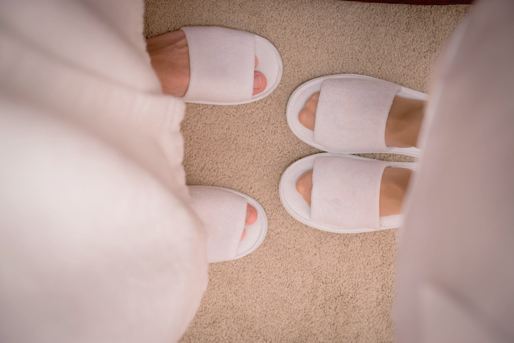 Couple wearing slippers and bathrobes | Reasons Why Nonskid Spa Slippers Are The Best Option For Your Spa | women's spa slippers