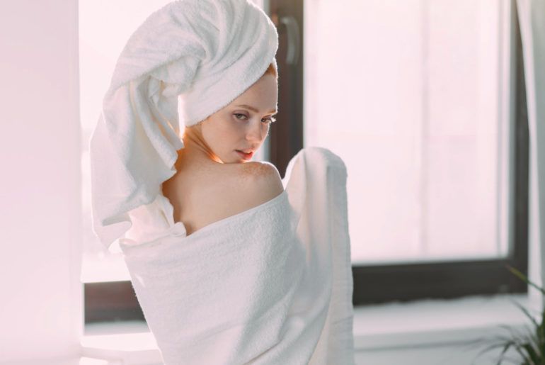 Rear shot of slim young female model wrapped in towel with turban on head | How To Choose The Best Luxury Bath Towels | luxury towels | luxury beach towels | Featured