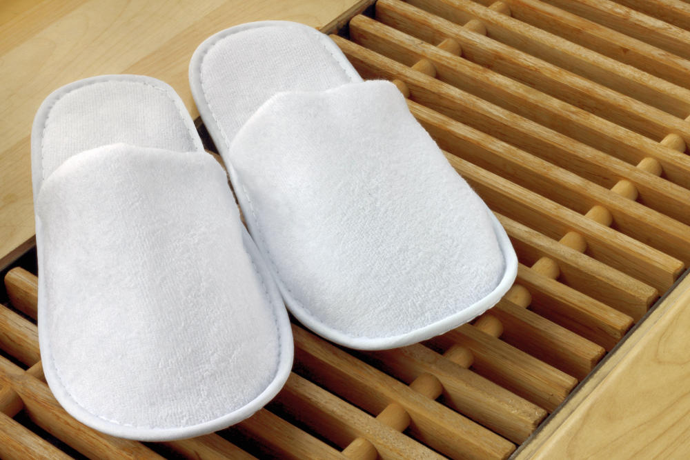 Spa slippers close on wooden planks floor | Reasons Why Nonskid Spa Slippers Are The Best Option For Your Spa | mens spa slippers