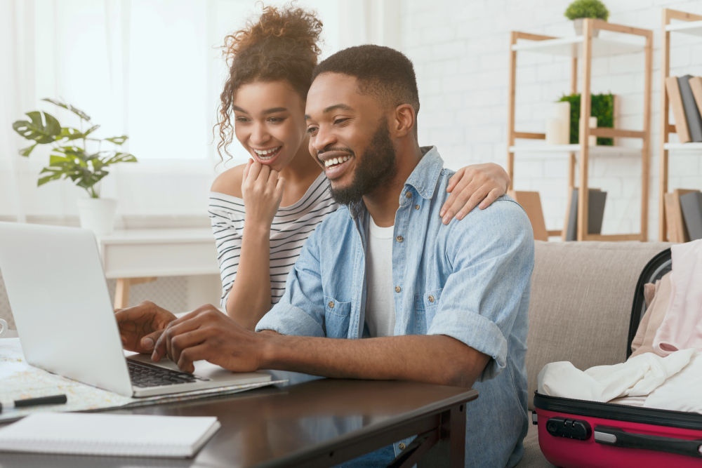 African-American Couple Searching Tour Online On Laptop | Expert Hosting Tips For A Superb Airbnb Hosting | airbnb hosting