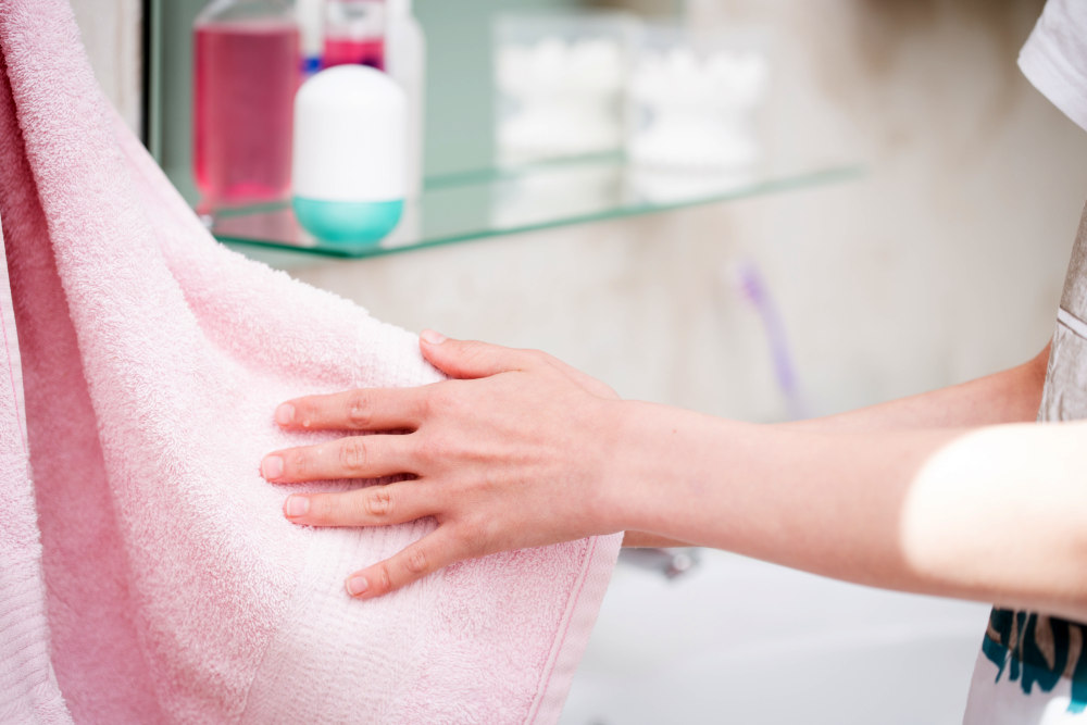 The boy is washing his hands in the bathroom | Why A White Towel Should Be A Bathroom Staple | white hand towel