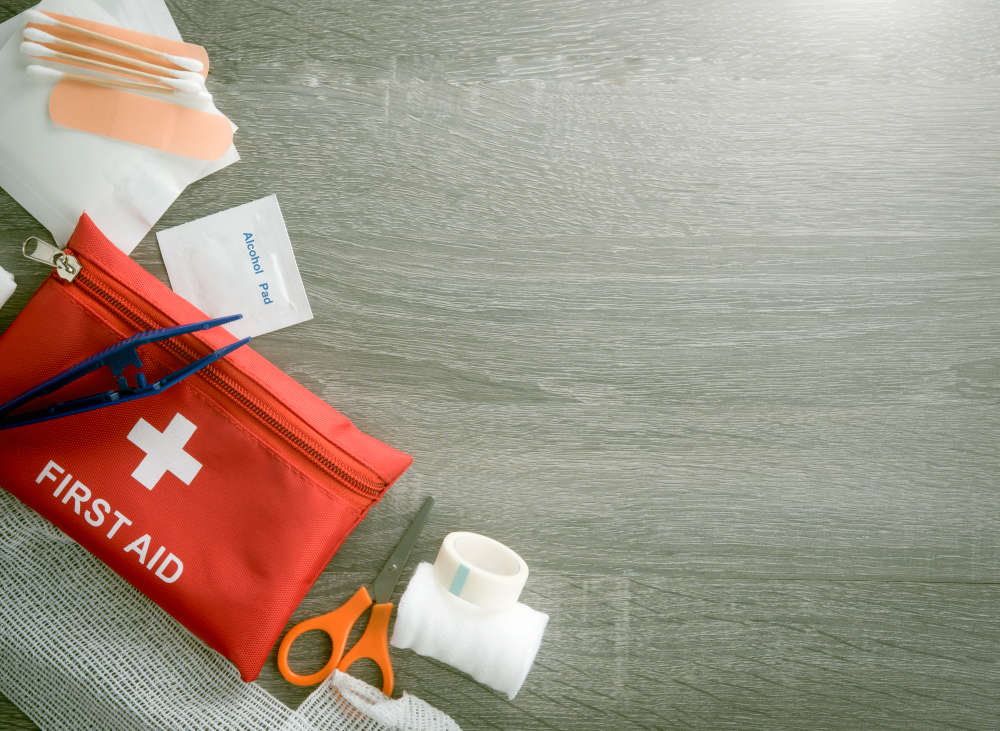 First aid medical kit on wood background | Airbnb Bathroom Essentials To Stock For Your Guests | airbnb essentials