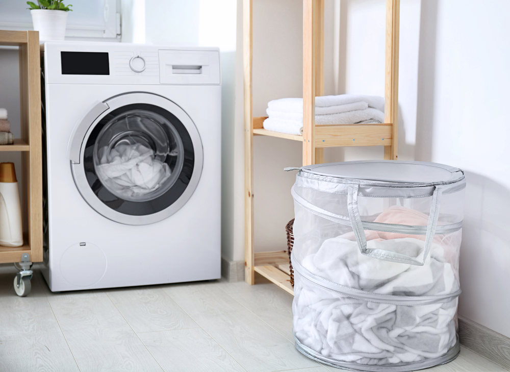 Laundry basket and washing machine indoors | Why A White Towel Should Be A Bathroom Staple | absorbent towels