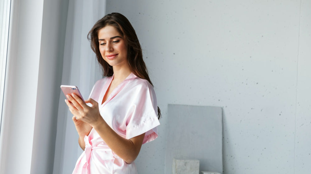 beautiful young woman wearing robe standing