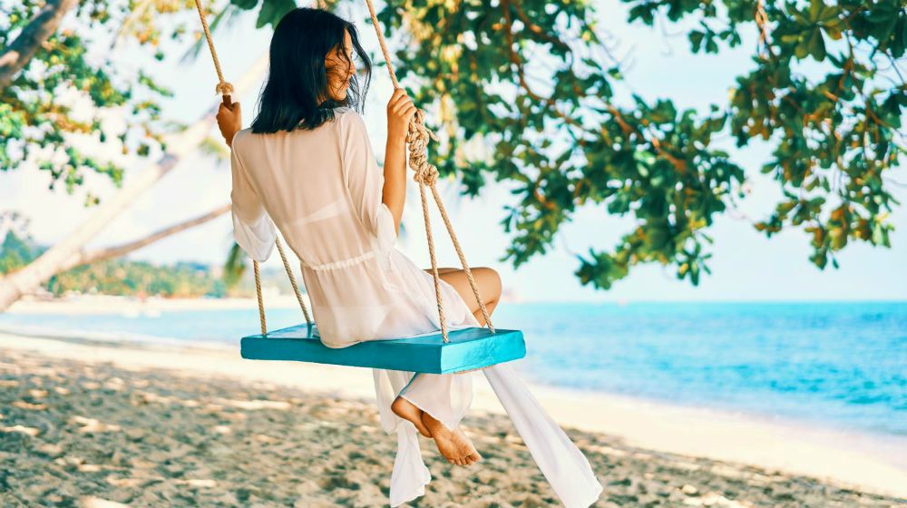 woman on swing wearing silk robe