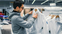 male customer inspecting bathrobe before buying it